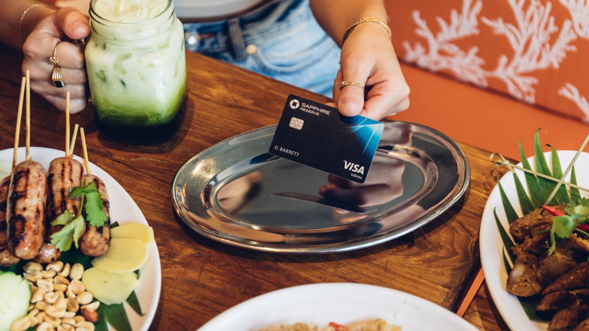 A restauranteur paying for their meal with a Chase Sapphire card
